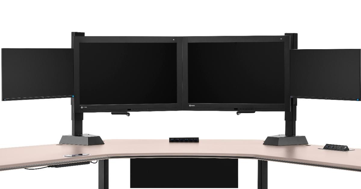 wide desk with multiple computer screens 